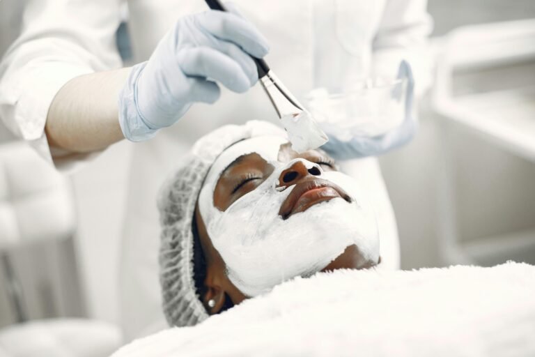 A relaxing facial treatment with a face mask applied by a professional in a spa.
